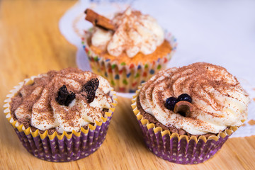 close up of cupcakes on wooden table