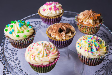 close up of colorful cupcakes on plate