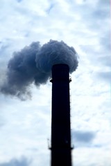 Smoke from smokestack of industrial factory pollutes air 