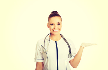 Female doctor presenting copyspace on the right