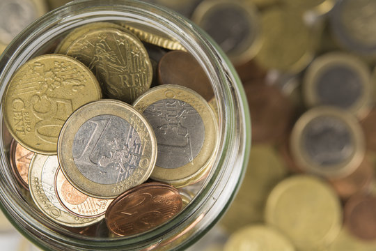 cash jar on a pile of coins
