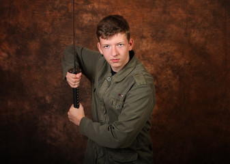 Man with katana sword on brown batik  background
