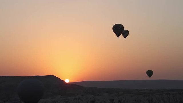Time-lapse of hot-air-balloons at sunrise.
