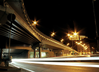 Fototapeta na wymiar Street lighting and car lights traces at night city