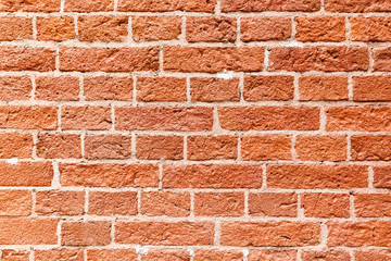 Old wall of broken red brick