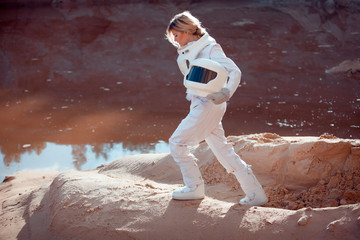 Water on Mars, futuristic astronaut without a helmet in another