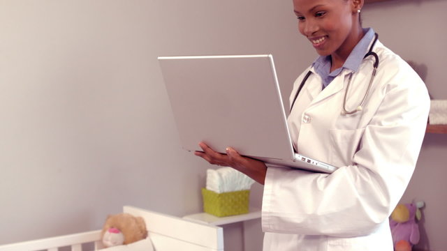 Smiling doctor looking at her computer