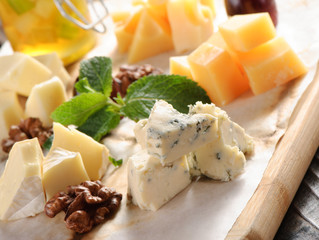 Assorted cheese on a wooden board