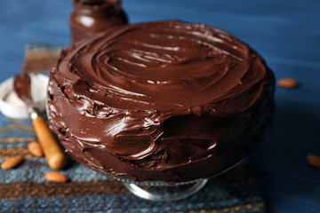delicious chocolate cake with almond on blue background