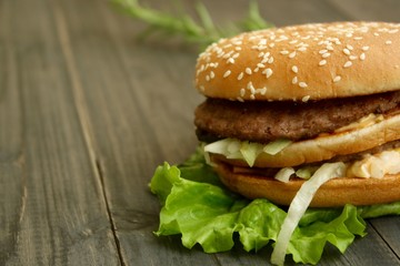 Hamburger and fries on a wooden cutting board