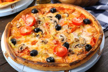 Pizza on wooden table closeup