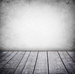 Grunge wall and wood paneled floor, interior of a room.