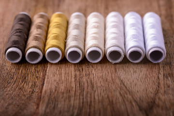 cotton sewing from white to brown on wood