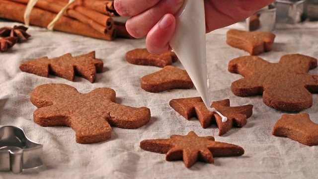 Making and glazing christmas cookies with cookie cutters