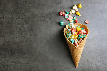 Coloured popcorn in the waffle cup on dark background