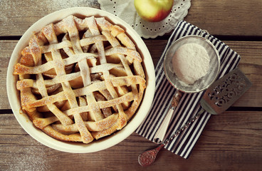 Homemade apple pie on wooden background