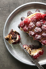Sweet cake with raspberries on dark background