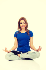 Young woman in lotus yoga pose.