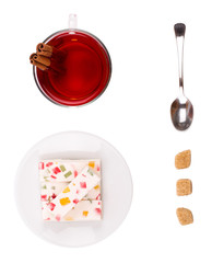 Tea and fruit candy on a white background