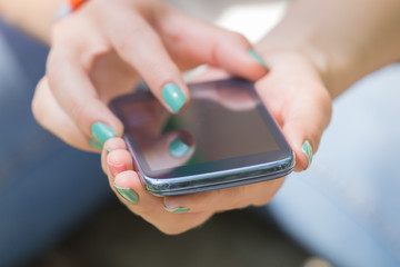 Texting on a smartphone. Shallow depth of field.