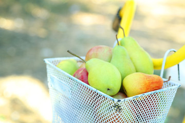 Basket of juicy fruits on bike, outdoors