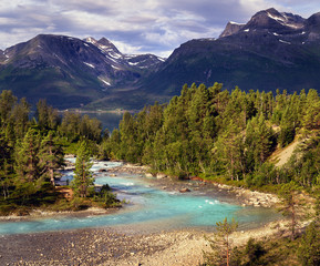 Blue river in northern Norway mountains near fjord