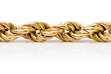 Detail of a tricolor golden twisted chain isolated on a white background