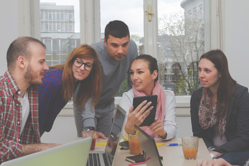 Young group of people discussing business plans.