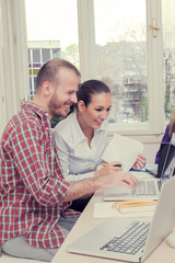 Young group of people discussing business plans.