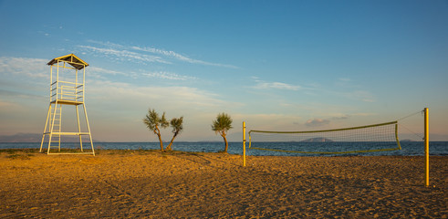 Volleyball tower and net on sandy beach
