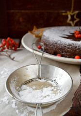 Homemade chocolate Christmas cake sprinkled with sugar powder