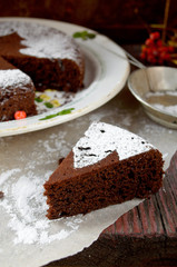 Homemade chocolate Christmas cake sprinkled with sugar powder