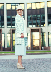 young blond woman walking on the street