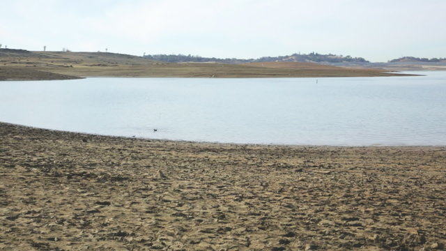 Panning view of a portion of the dried lakebed of Folsom Lake during drought conditions, January 2014.