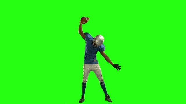 American football player triumphing with raised arms 