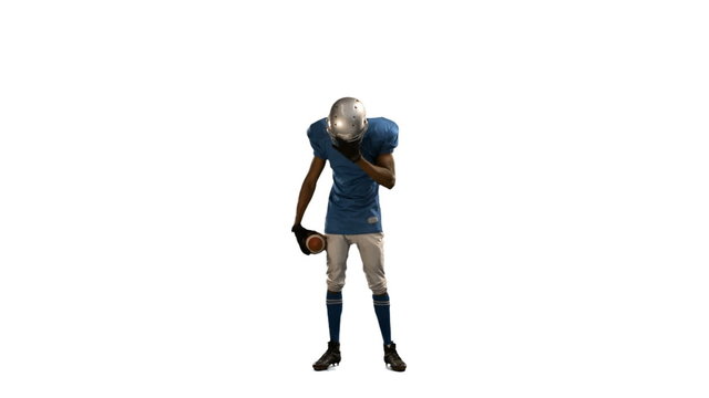 Disappointed american football player looking down