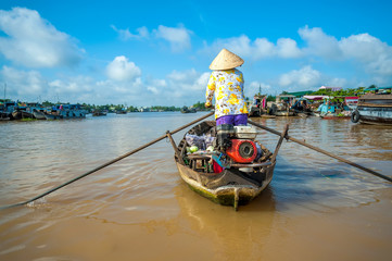 Woman rowing boat on floating market