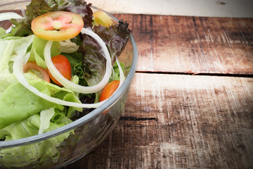 Fresh healthy salad on wooden table. View from above with copy space