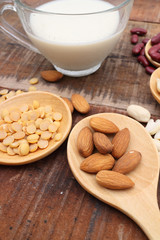 Soy milk or Almond milk with almond and soy bean on a wooden table