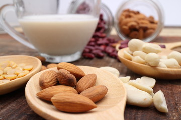 Soy milk or Almond milk with almond and soy bean on a wooden table