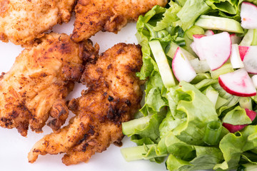 fried chicken with salad and potatoes - close up