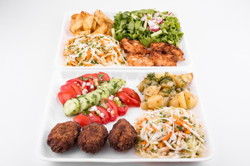 fried meatballs and chicken with salad and potatoes