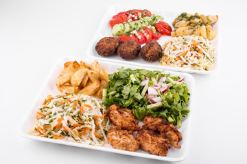fried meatballs and chicken with salad and potatoes
