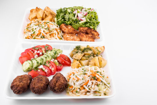 fried meatballs and chicken with salad and potatoes - copy space