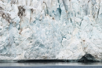 Close up of blue ice in the glacier by the sea, Svalbard