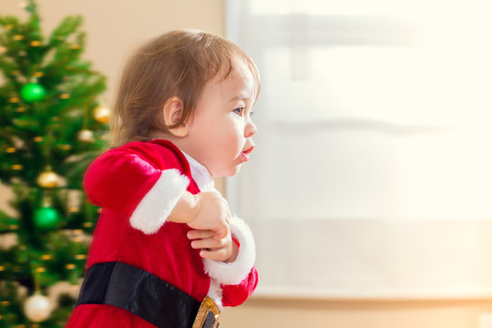 Little Toddler Girl Running To Open Christmas Presents