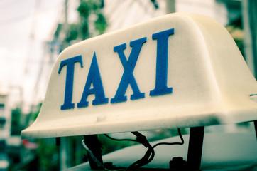 Old taxi sign on roof top car. Bangkok, Thailand
