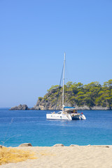 The white catamaran anchored near beach

