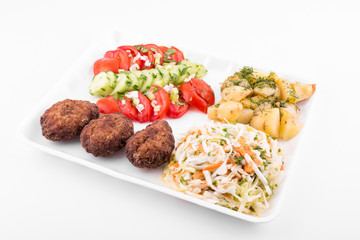 fried meatballs with salad and potatoes