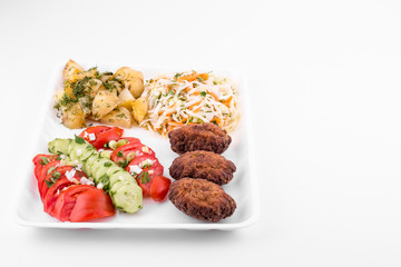 fried meatballs with salad and potatoes - copy space